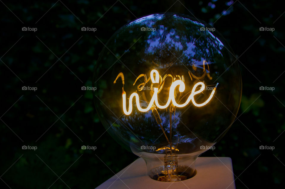 ‘Nice’ in mirror image, as can be seen from the reflection in the glass lamp