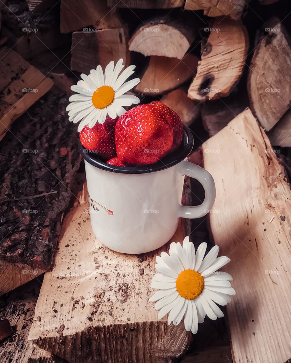 metal mug with strawberries