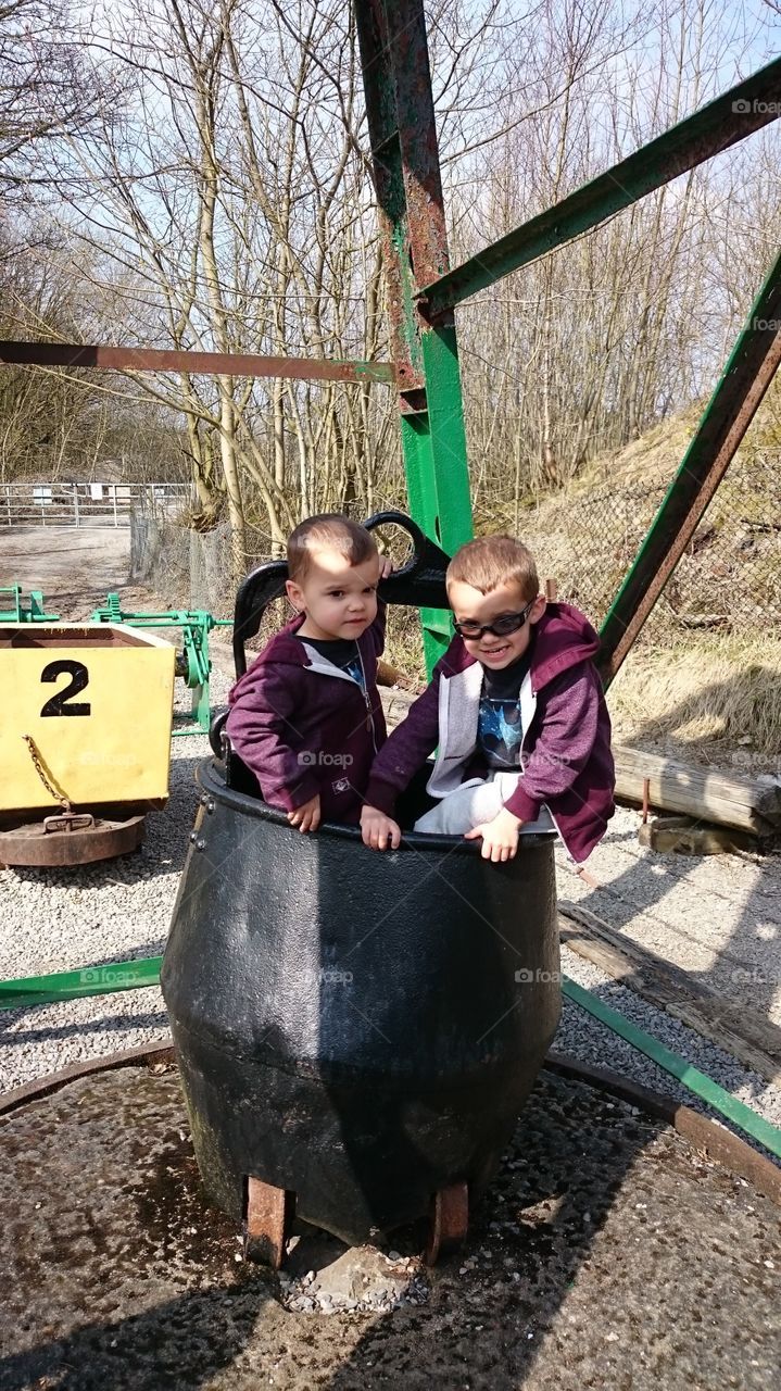 Two twins brother sitting container
