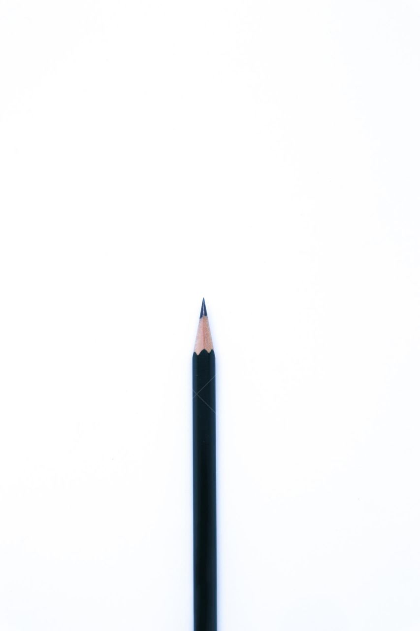 A Black Pencil with Flat Lay Shot in The White Background, Portrait Mode and Minimalist
