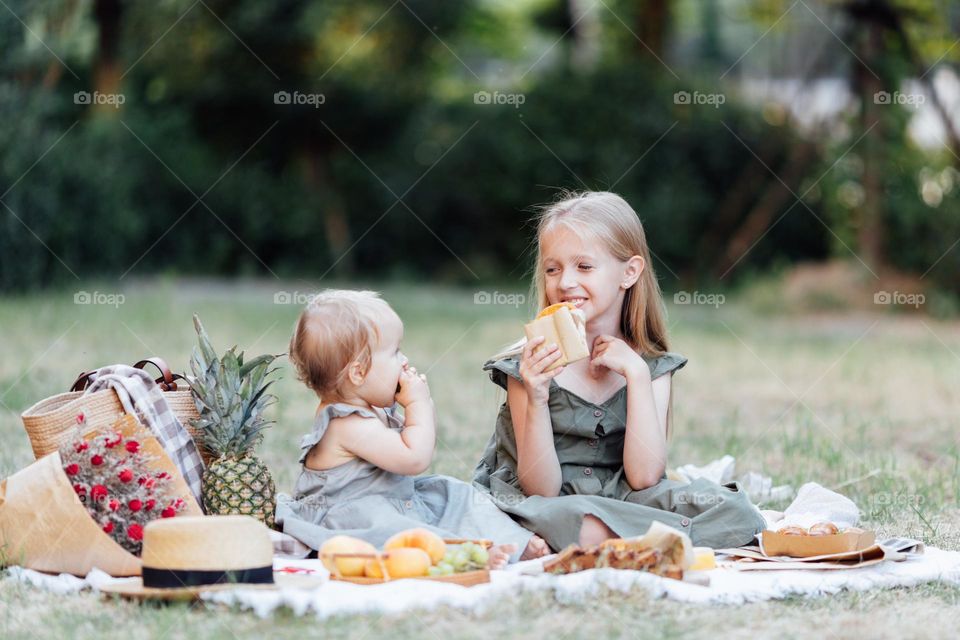 Kids having picnic in park at summer