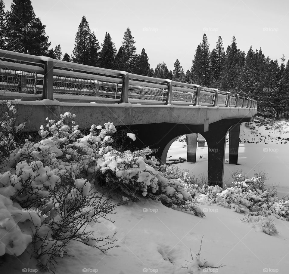 A bridge over the Deschutes river with snow in the winter 