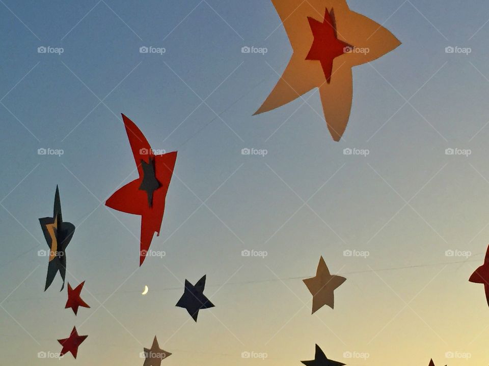 Colorful stars and small moon . Colorful stars made of paper and true moon in the sky 