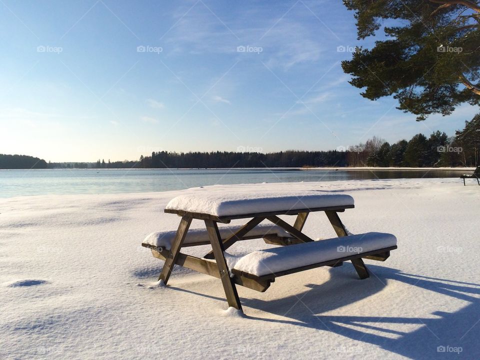 Picnic bench covered in snow