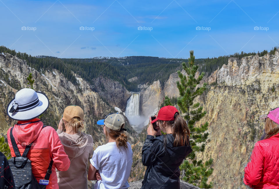 Young people enjoying the waterfall in Yellowstone National Park