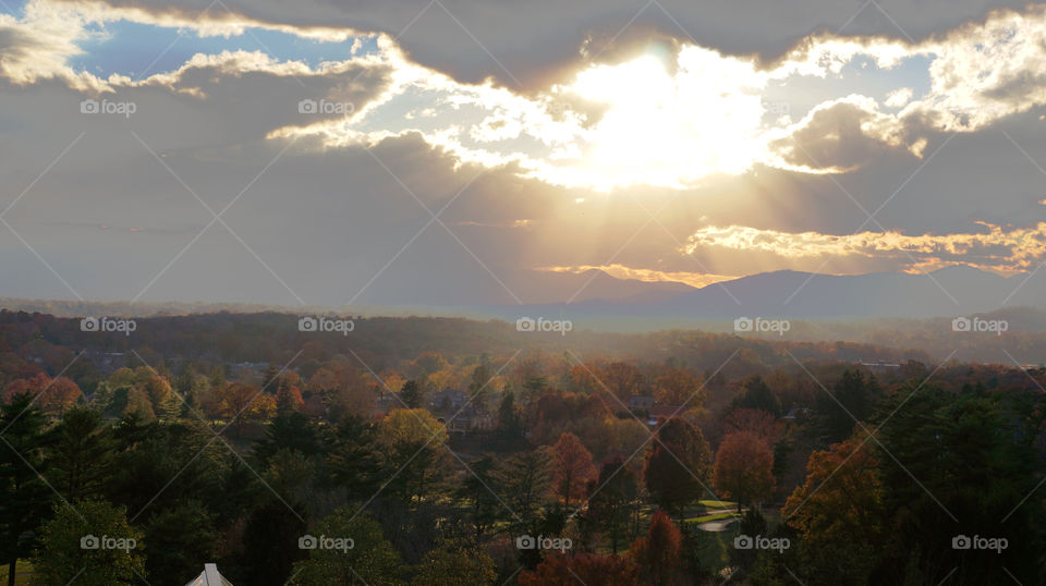 The Autumn sun beaming above Asheville NC on a Fall day just before sunset. 