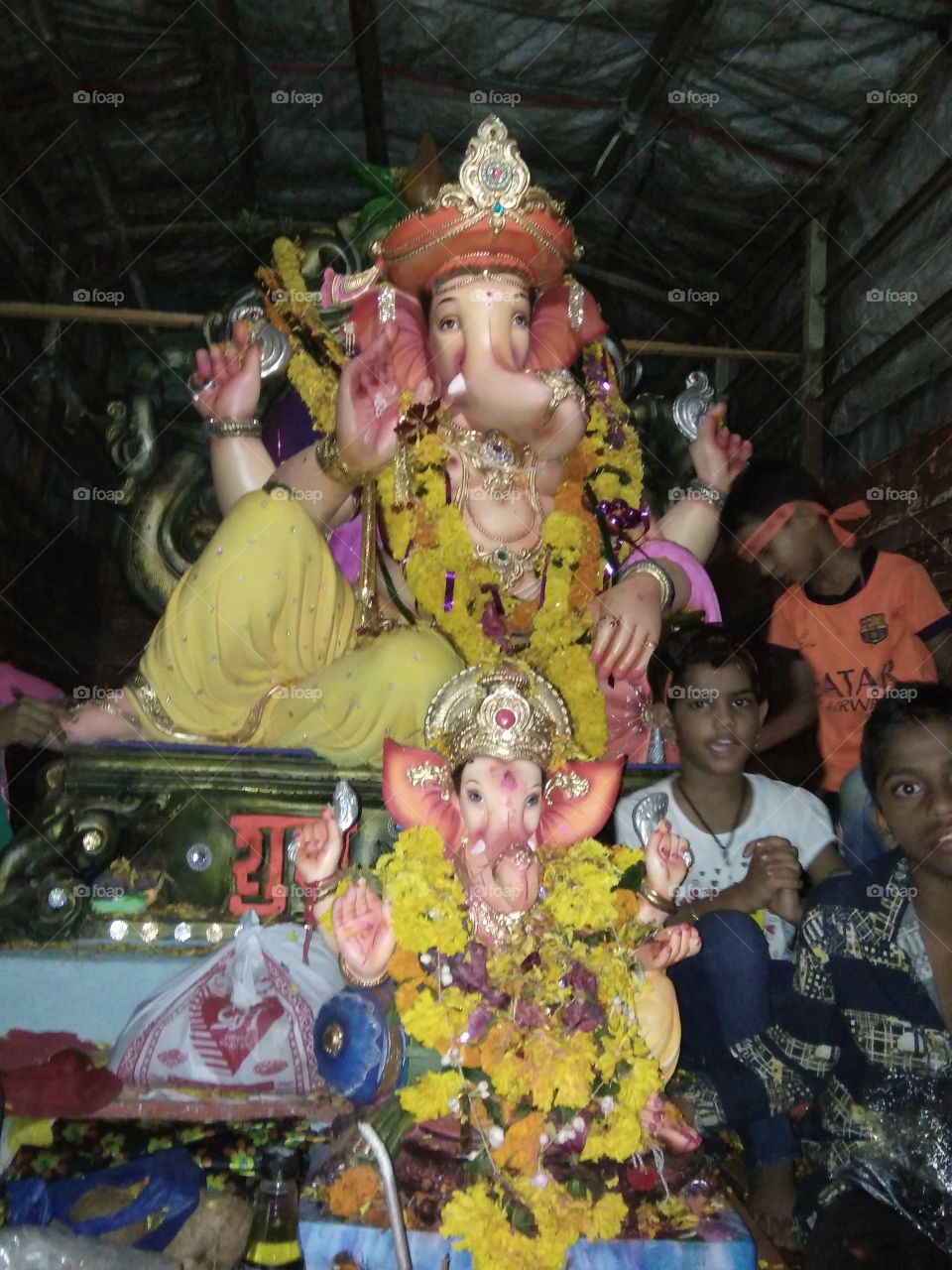 Ganesh Chaturthi (IAST: Gaṇēśa Chaturthī), also known as Vinayaka Chaturthi (Vināyaka Chaturthī) is the Hindu festival that reveres god Ganesha.[1] A ten-day festival, it starts on the fourth day of Hindu luni-solar calendar month Bhadrapada, which typically falls in Gregorian months of August or September. The festival is marked with installation of Ganesha clay idols privately in homes, or publicly on elaborate pandals (temporary stage). Observations include chanting of Vedic hymns and Hindu texts such as Ganapati Upanishad, prayers and vrata (fasting).[1] Offerings and prasada from the daily prayers, that is distributed from the pandal to the community, include sweets such as modaka believed to be a favorite of the elephant-headed deity.[2][3] The festival ends on the tenth day after start, wherein the idol is carried in a public procession with music and group chanting, then immersed in nearby water body such as a river or ocean, thereafter the clay idol dissolves and Ganesha is believed to return to Mount Kailash to Parvati and Shiva.[1][4]