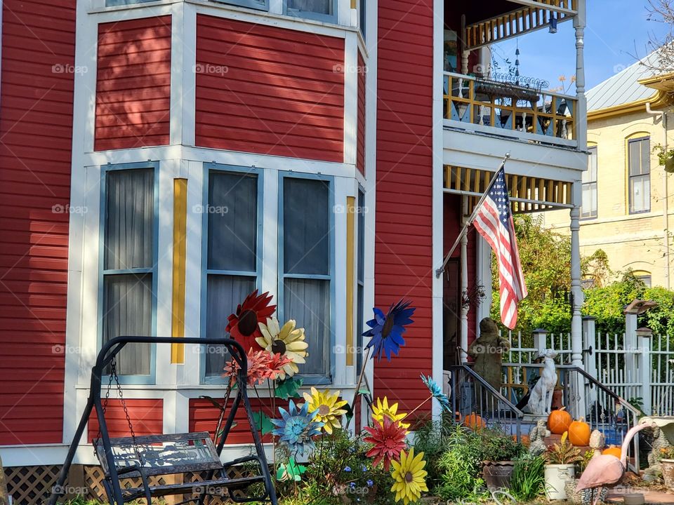 American flag on a colorful historic home