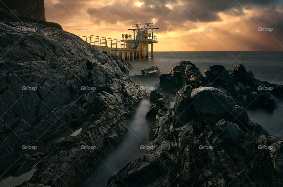 Dramatic sunrise scenery of Blacrock diving tower on Salthill beach in Galway, Ireland