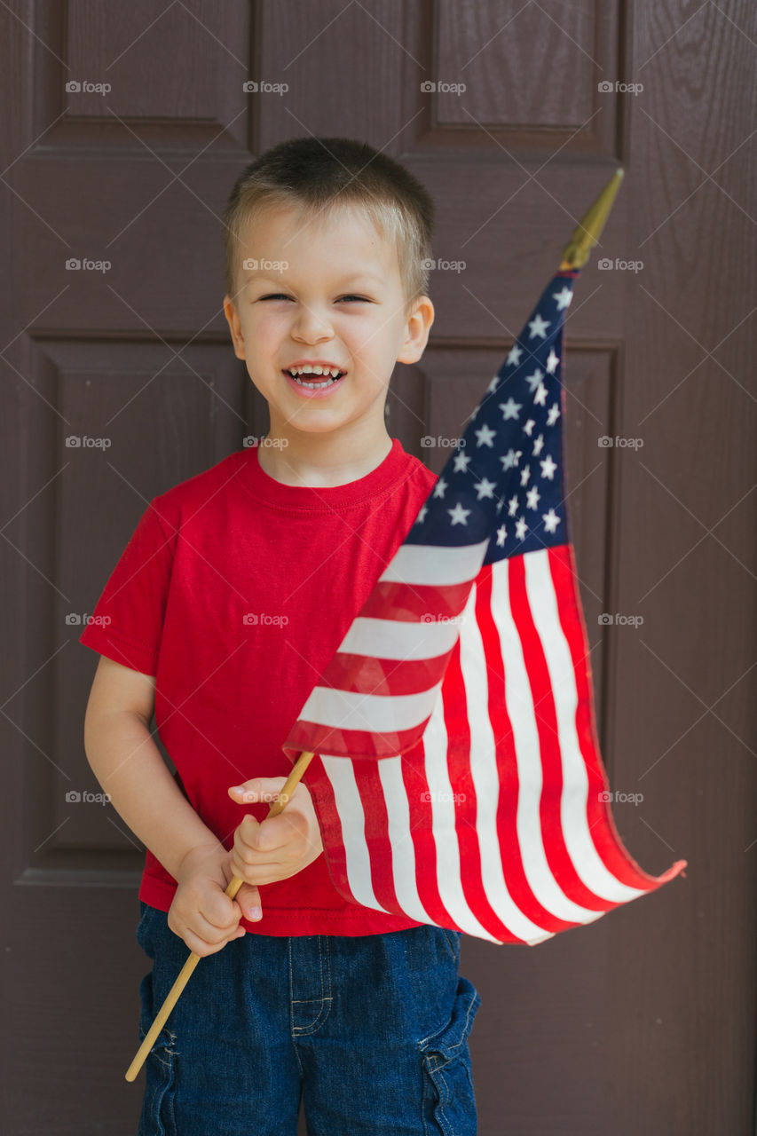 Toddler holding American flag 