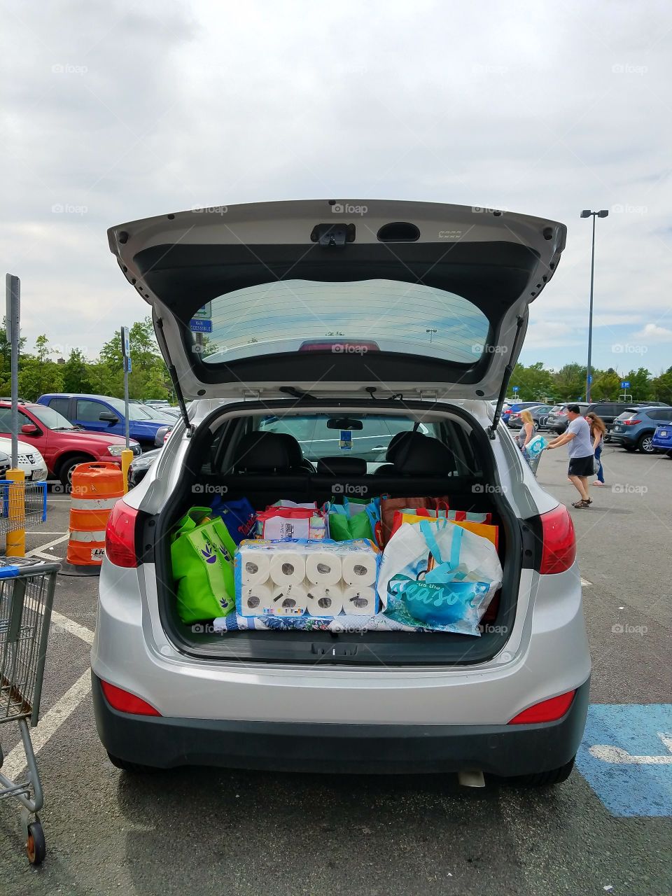 SUV open shows big grocery shopping day. Huge parking lot.