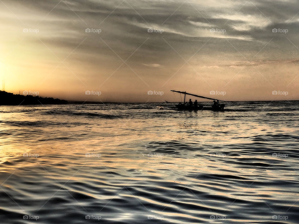 Traditional eastern Bali Fishing boat on the ocean at sunset 