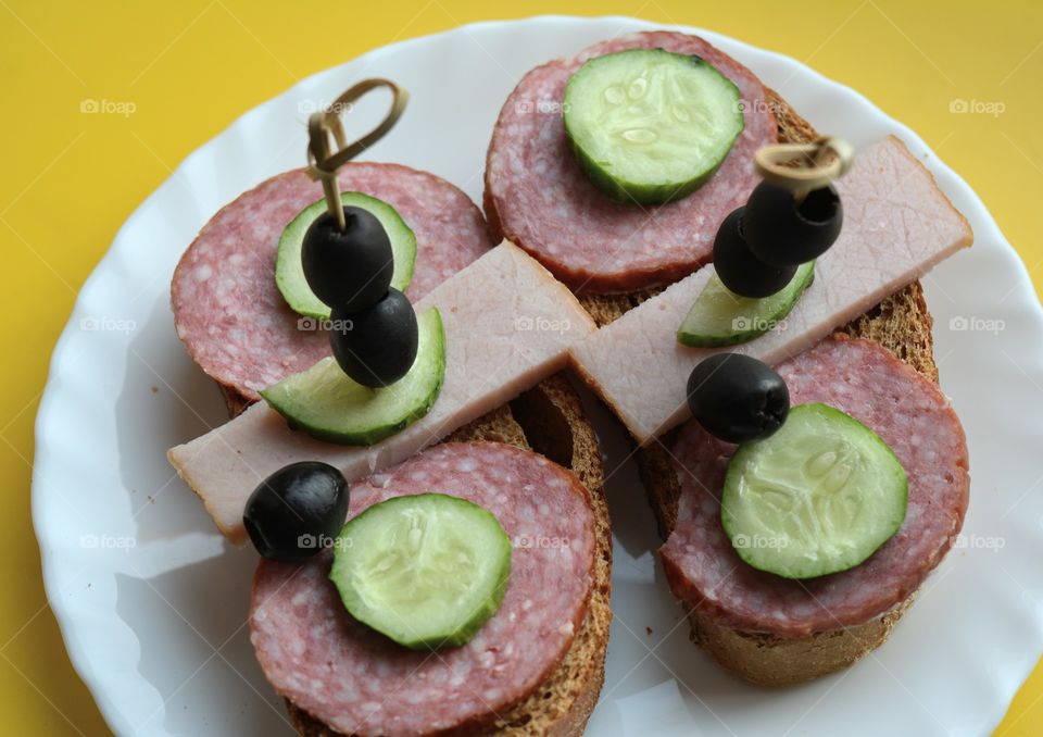 sandwiches with sausage and vegetables on a plate