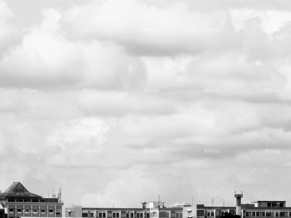 Clouds between towering buildings
