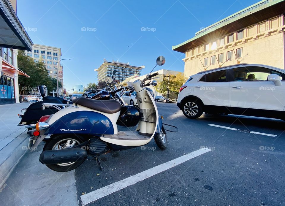 Scooter parked on side of street