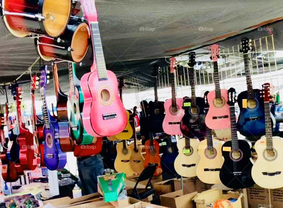 Colorful guitar stand at swap meet.