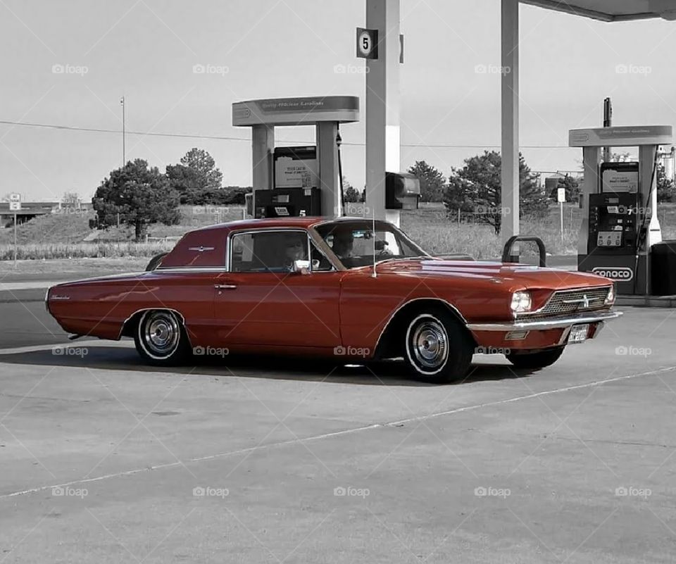 '66 color Thunderbird fueling up at B&W gas station