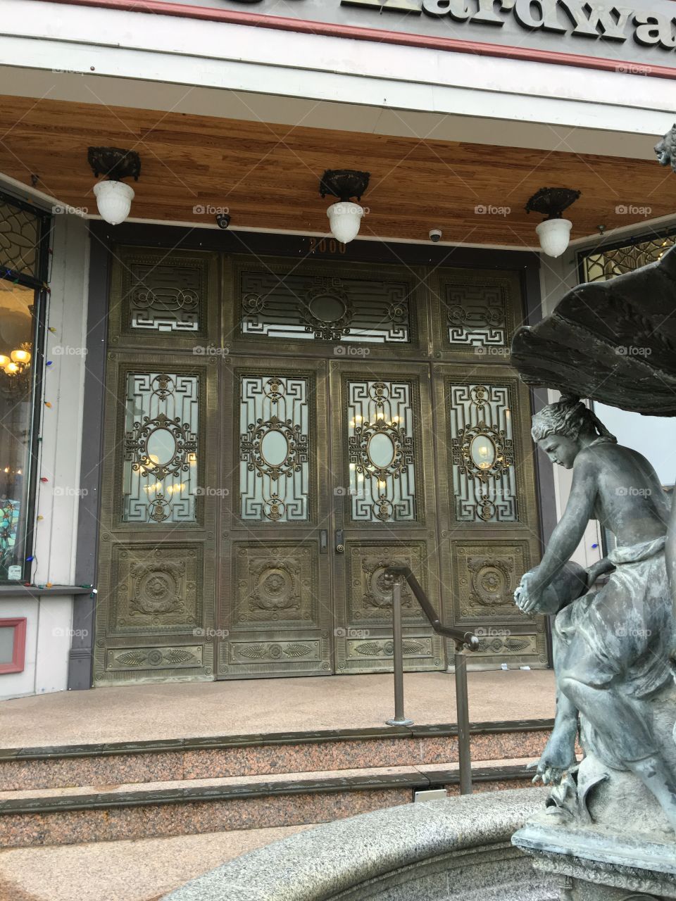 Beautiful door with a fountain statue in front of it. 