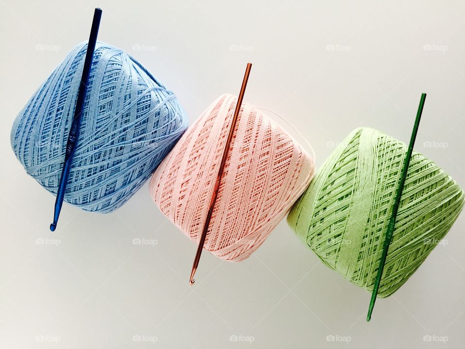 Knitting balls and knitting needles on white background