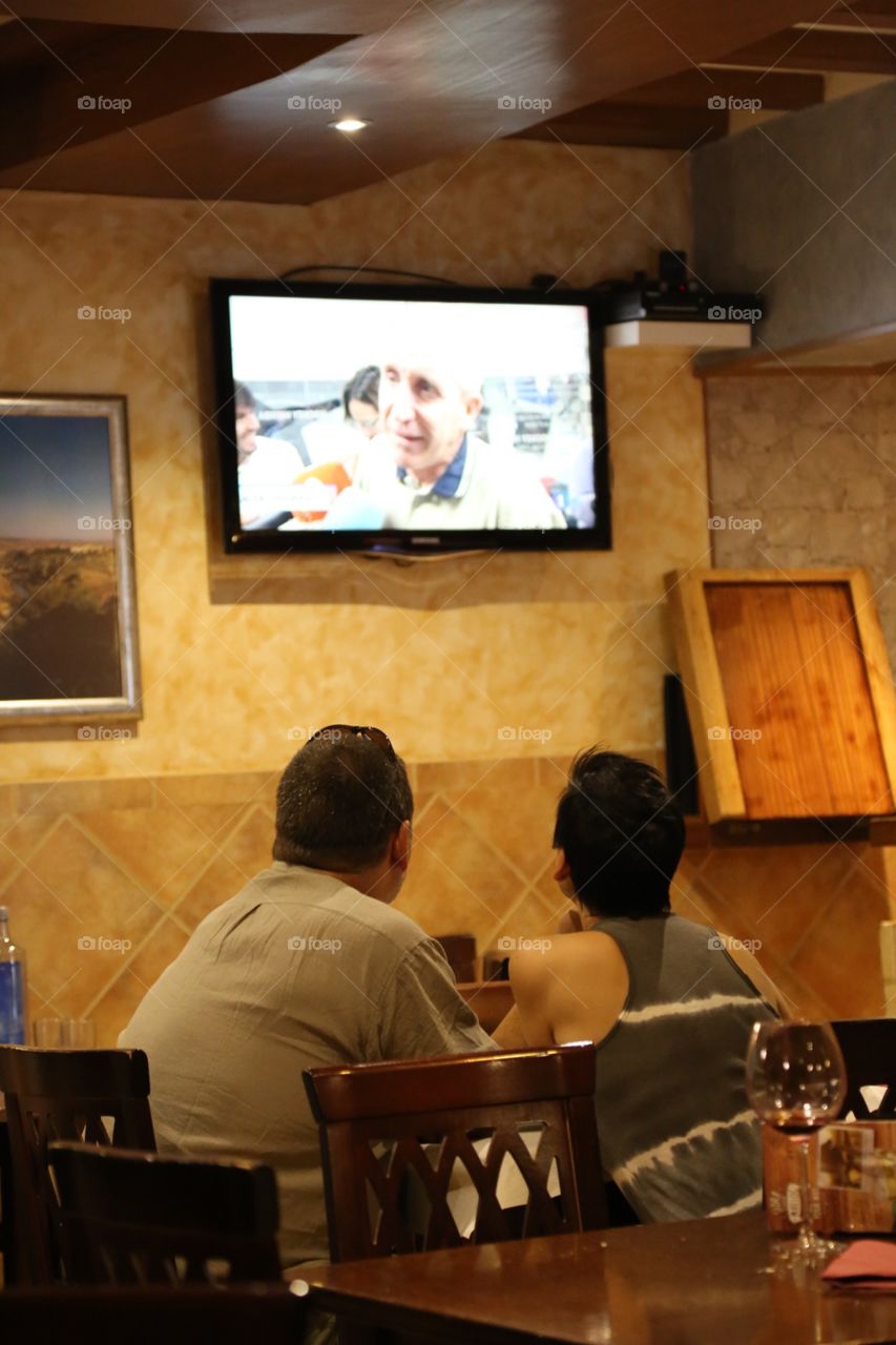 People watching tv in a restaurant