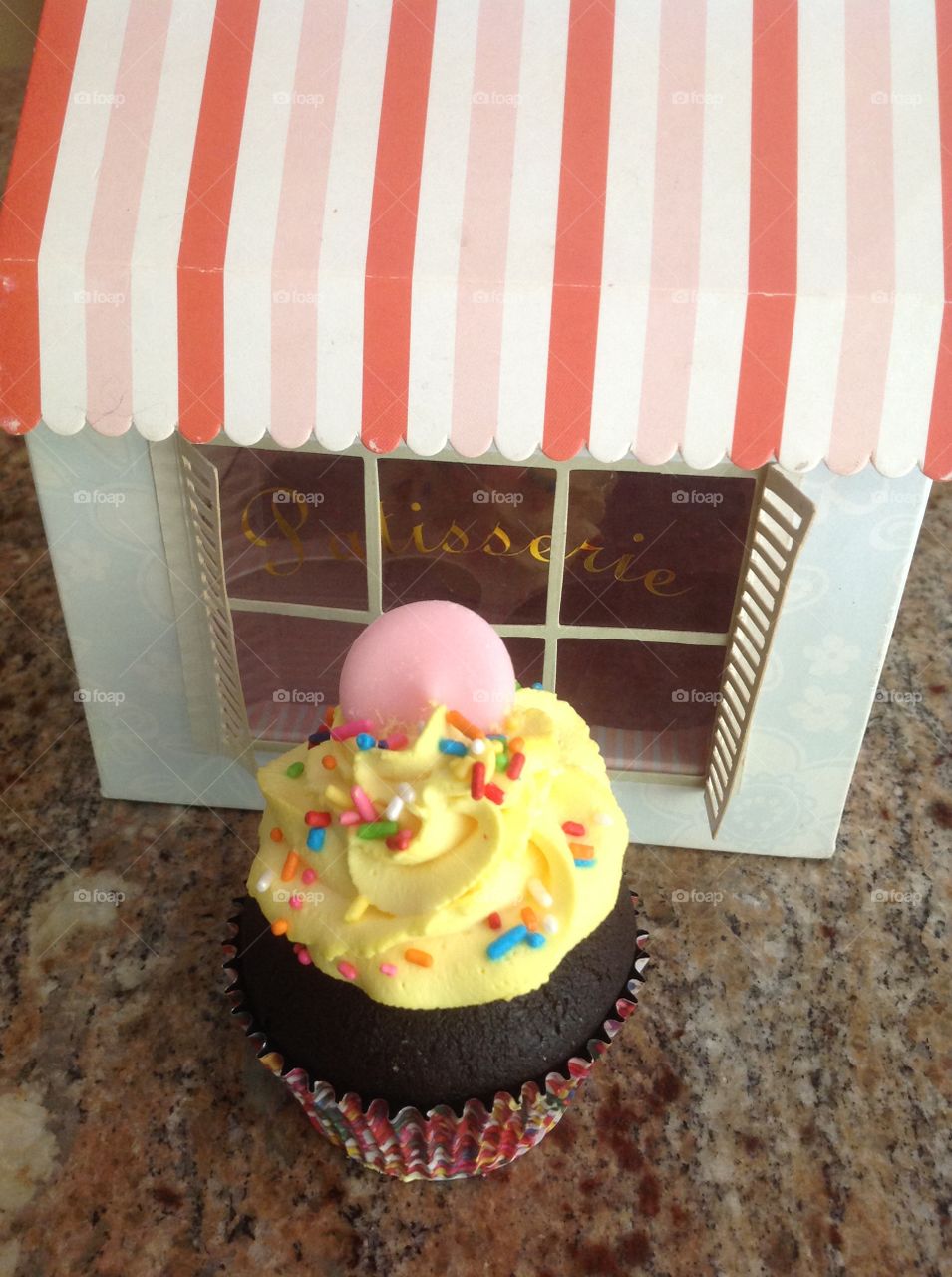 Delicious chocolate cupcake with rainbow sprinkles.