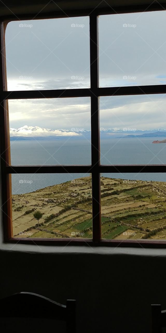 Window overlooking Lake Titicaca and distant mountains in Bolivia