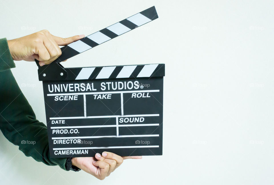 Man and clapper board for making video cinema in studio.Movie production clapper board or slate film concept.