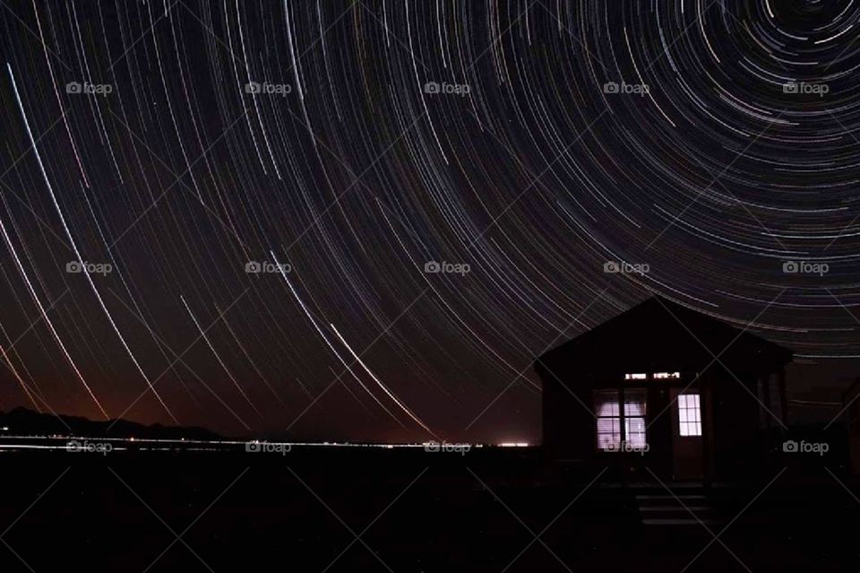 Star trails over a house