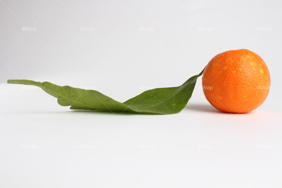 Mandarin and green leaf