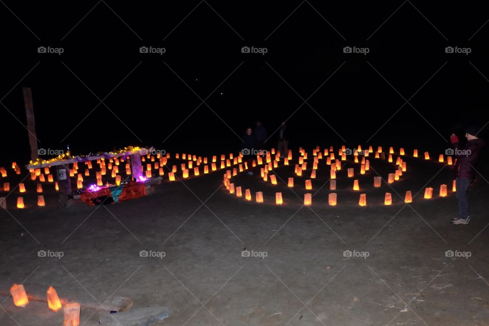 Labyrinth lighted up with paper lanterns for people to walk into