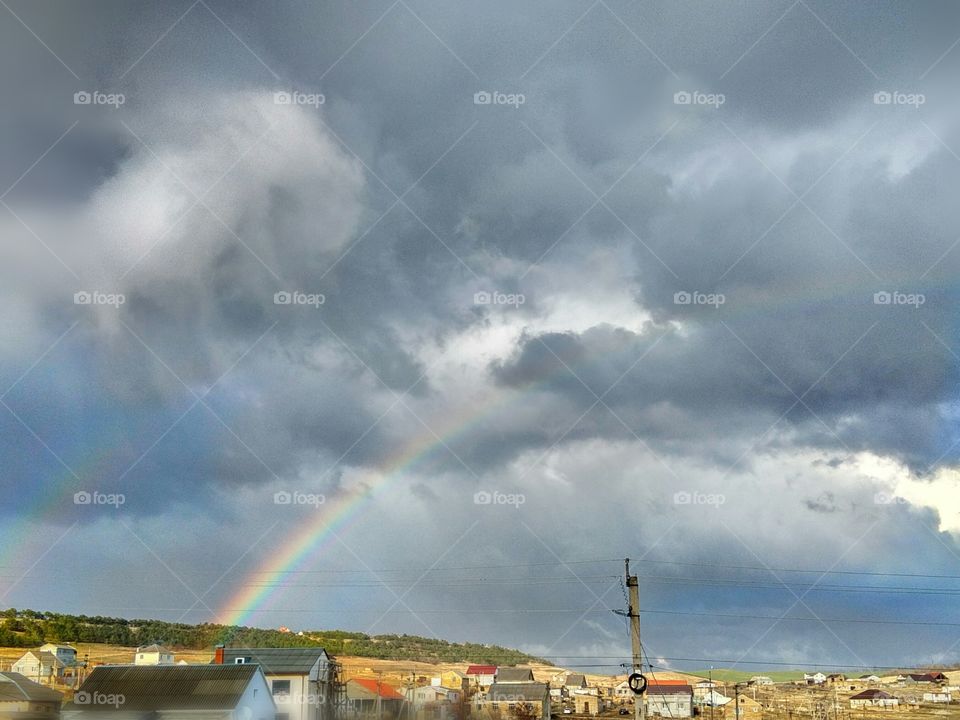 rainbow after the rain on the background of gray clouds,nature.