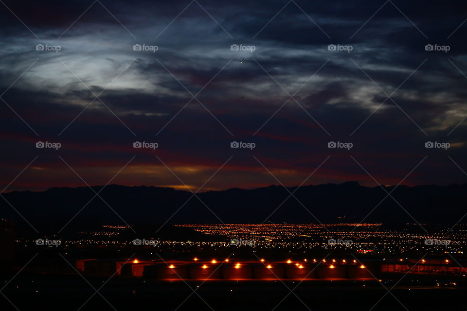 Illuminated city during sunset