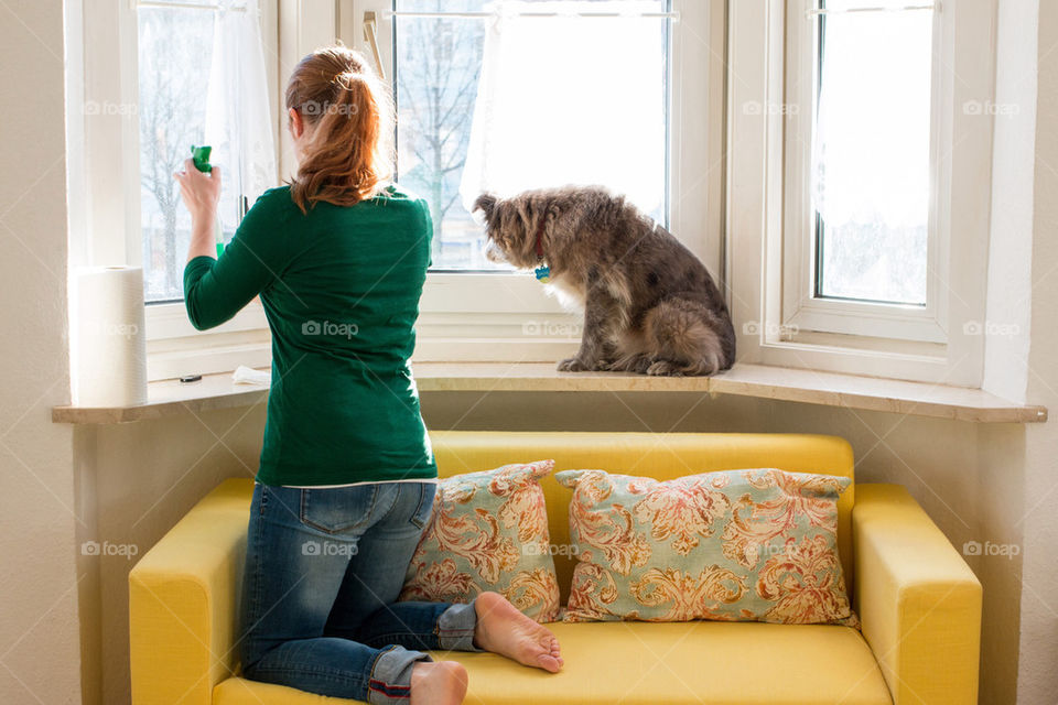 Woman cleaning window