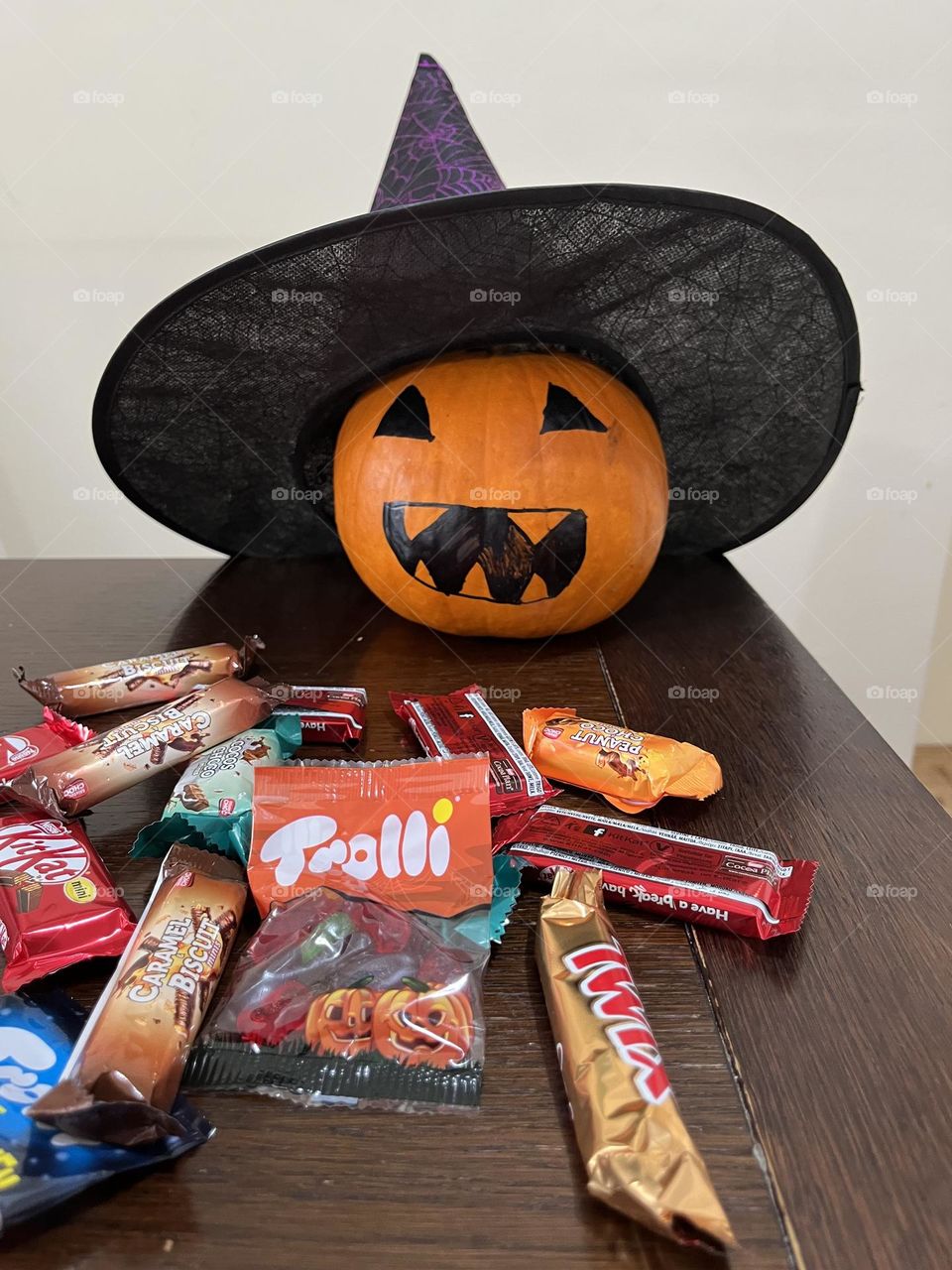 Pumpkin with witch’s hat and candy.