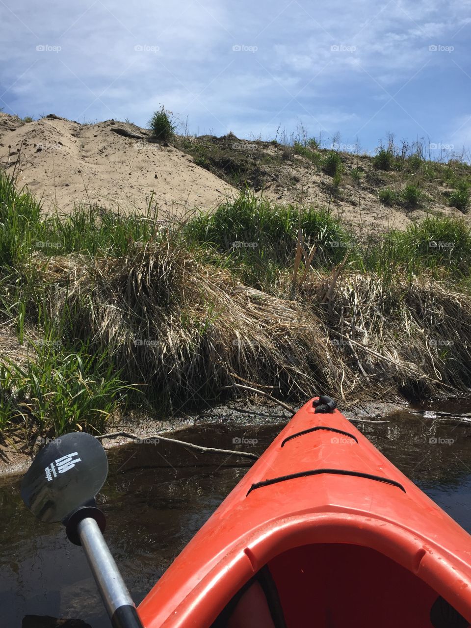 Kayak stop. Nose of kayak pulled up on sandy river bank 