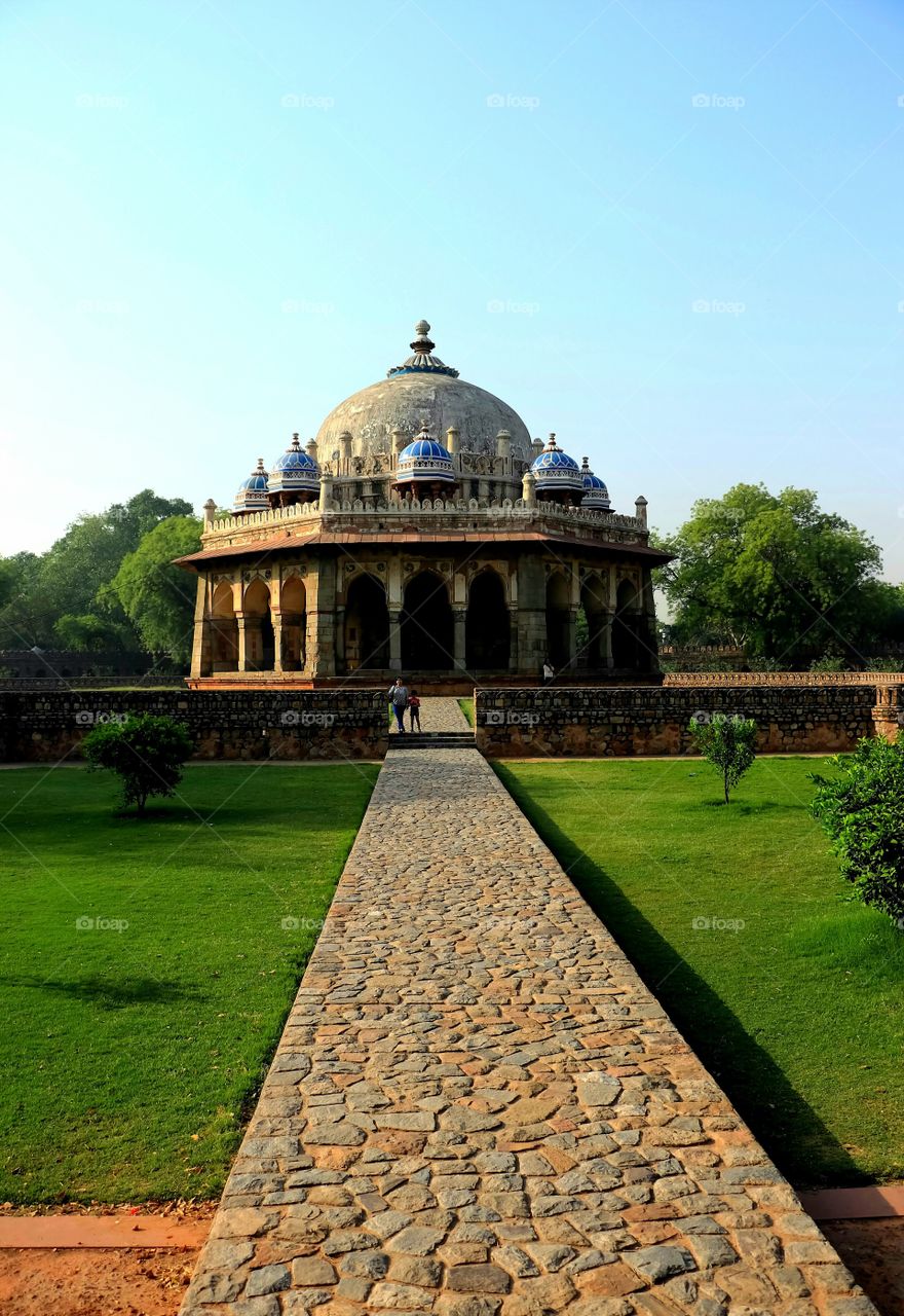 Heritage architecture. 
This is Isha Khan Tomb in Delhi. The ancient architecture beautifully popped up from the lush green grassland and surrounding trees.