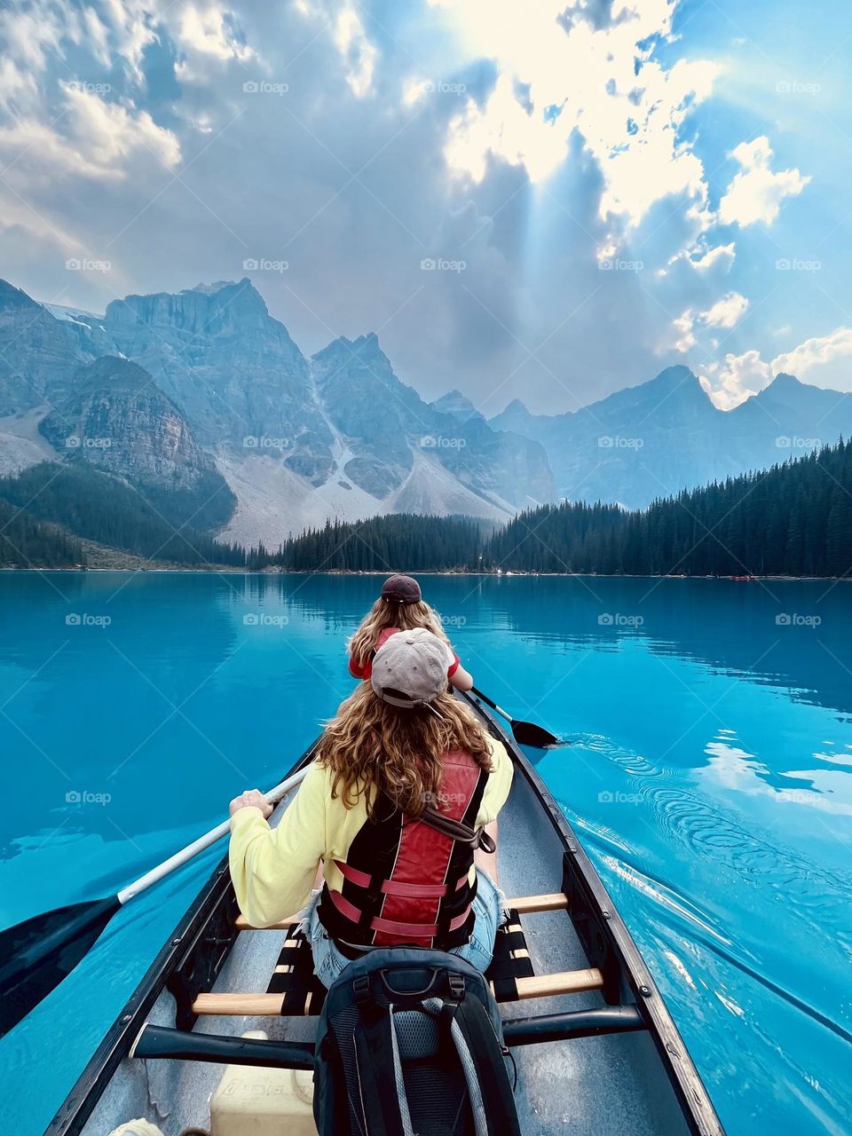 Paddling across the amazing glacial water of Moraine Lake, Banff National Park, Alberta, Canada.