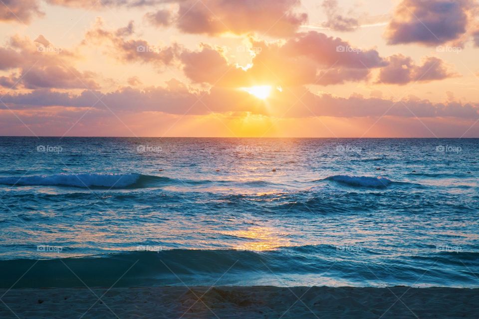 The warm glow of the first light over the beach.