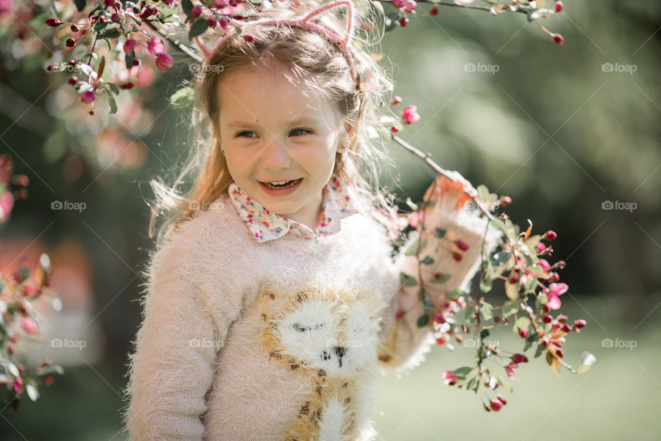 Cute Little girl in a blossom park