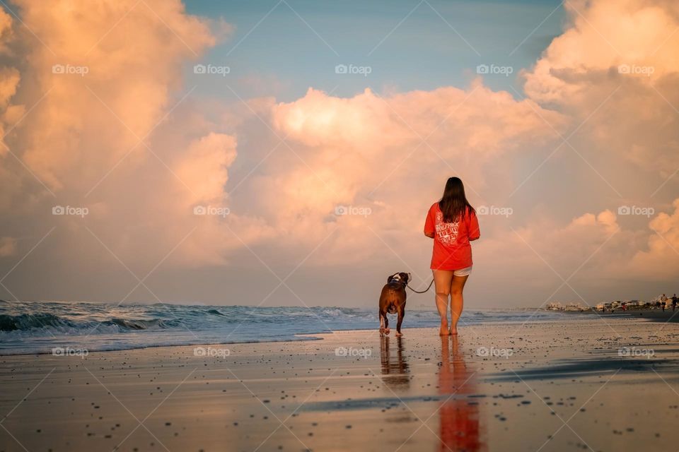 Best friends enjoy an early morning walk on the beach. Emerald Isle, North Carolina. 