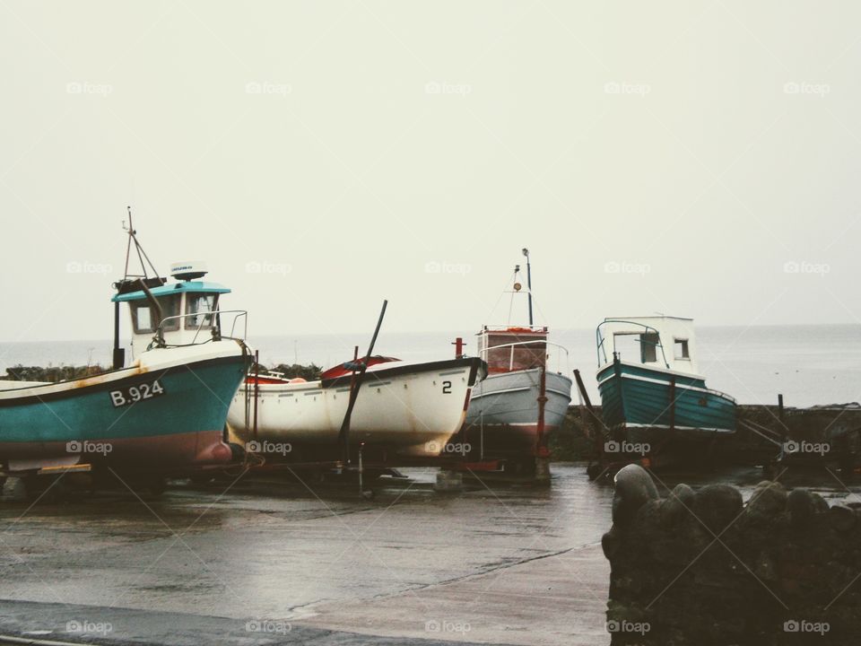 Boats dry docked by the seashore