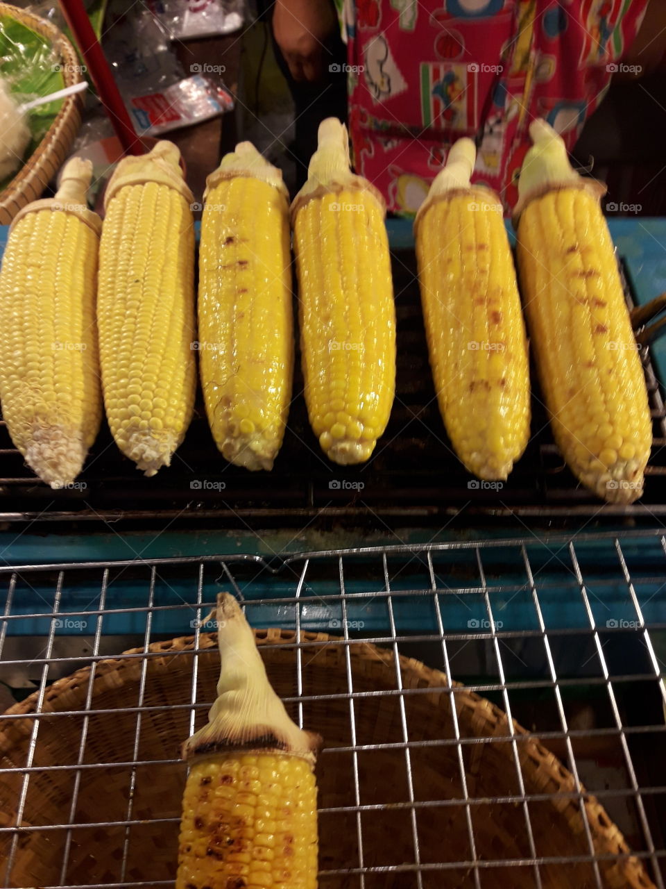 the corn after roasted until they are ripe. Their color become darker  and ready to eat.