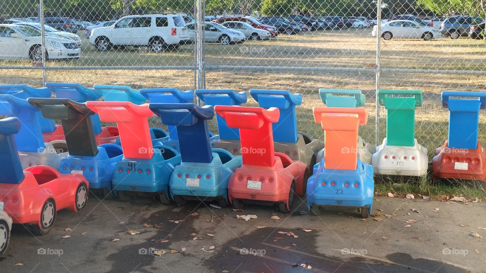 Bright colorful outdoor toy cars parked in neat rows