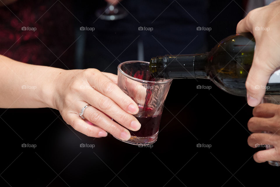 Person pouring red wine