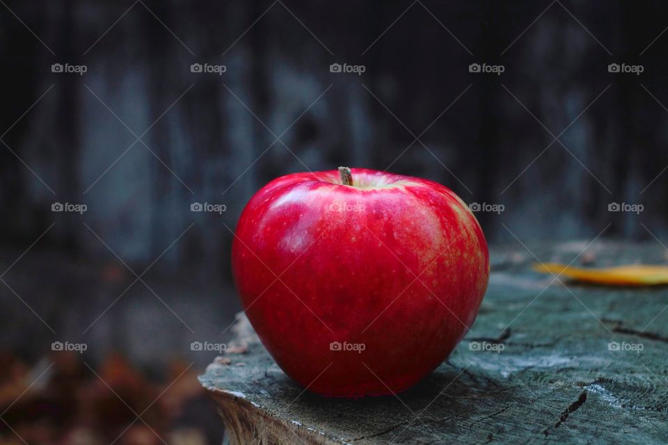 one apple on wooden background