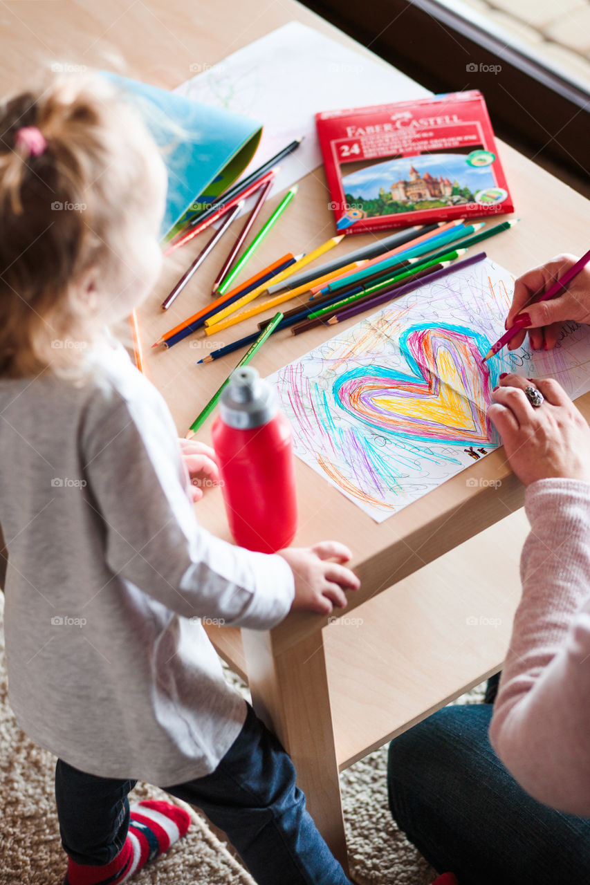 Colours of the world. Children with mom drawing using crayons