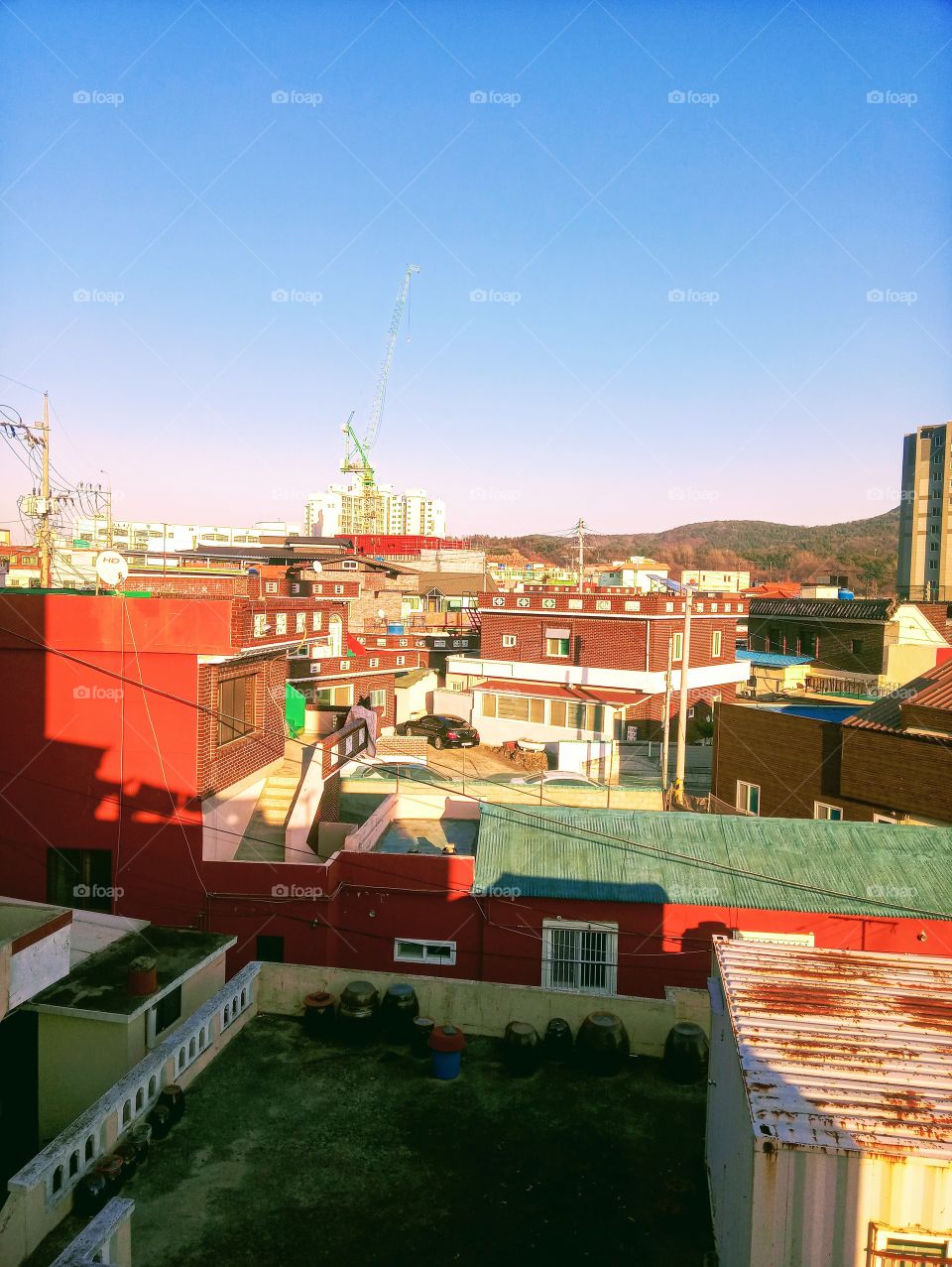 The neighbors houses,  some buildings and car.
The sight of the far mountains and the blue sky above it is the wonderful sight we have beside our home  in tongdosa South Korea.