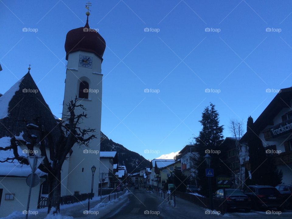The main Street of an alpine village on a morning with shadow 
