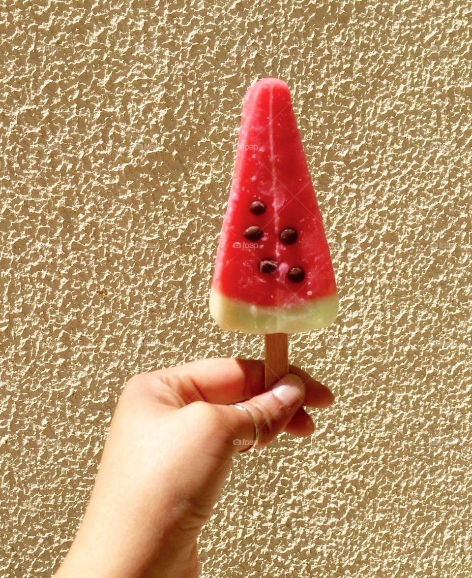 Watermelon pop stick holding in hand