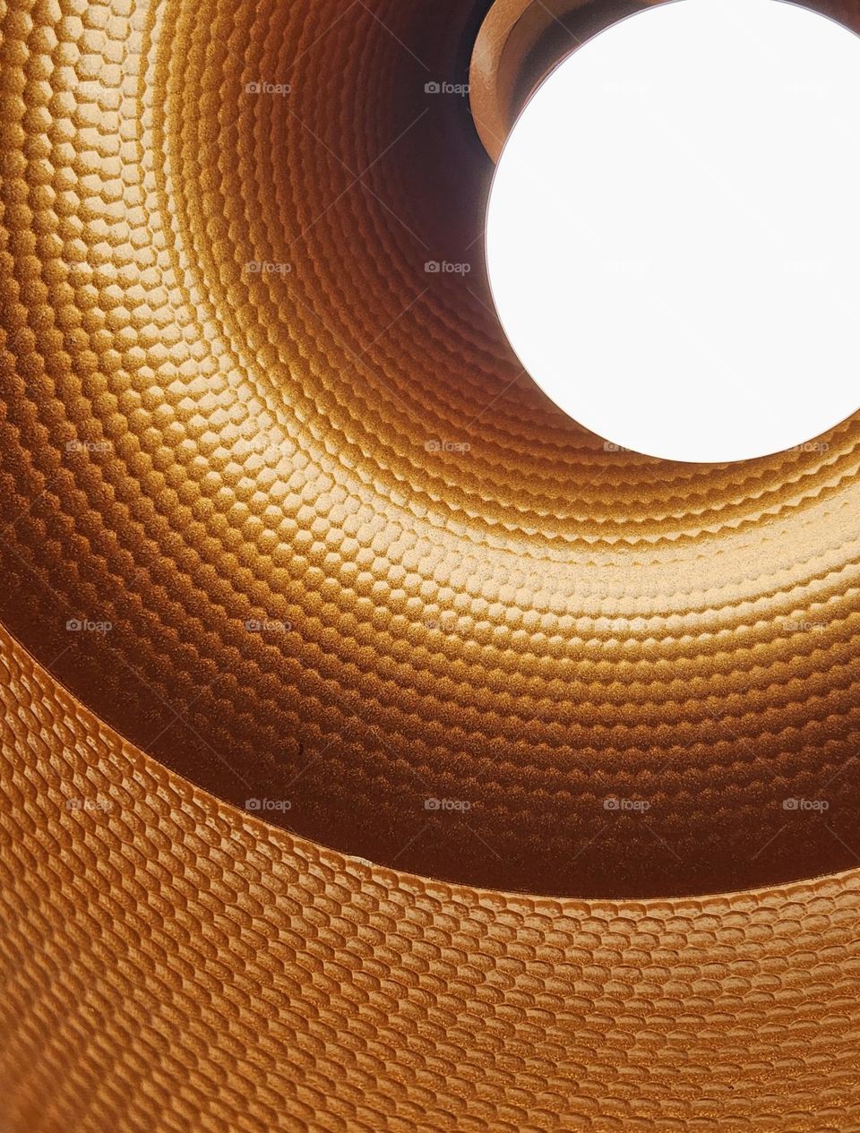 close up view of a light bulb inside a metal hanging lamp in an American restaurant